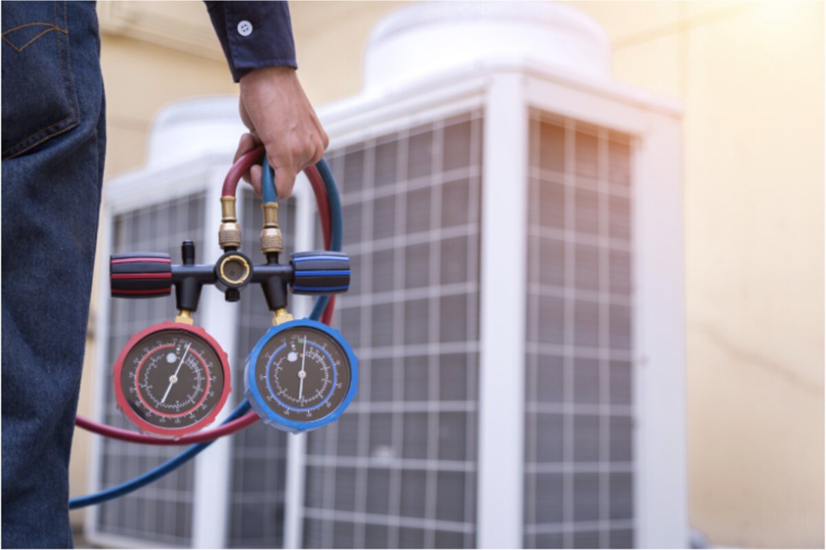 HVAC technician checking an outdoor air conditioning system